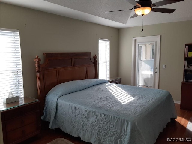 bedroom featuring ceiling fan and dark wood-type flooring