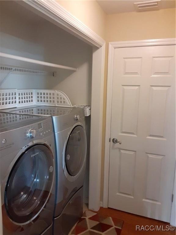 clothes washing area with separate washer and dryer