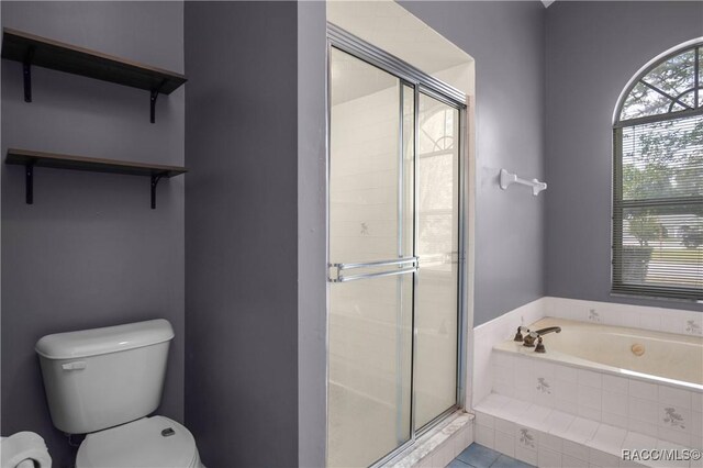 bathroom featuring toilet, a shower stall, and a bath
