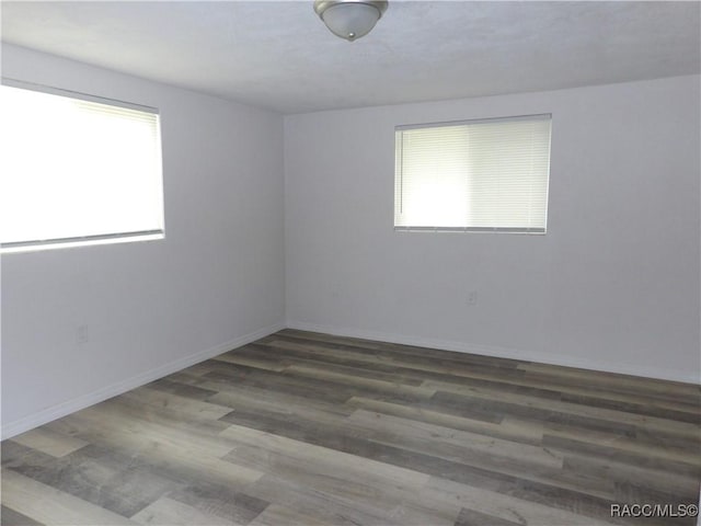 empty room with dark hardwood / wood-style floors