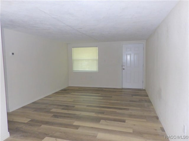 spare room with hardwood / wood-style floors