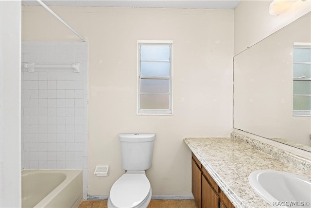 full bathroom featuring vanity, toilet, and tiled shower / bath combo