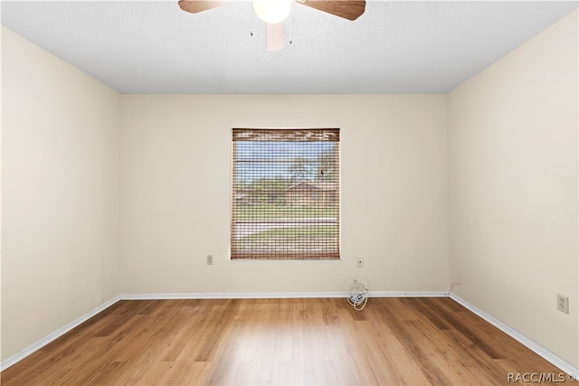 spare room featuring ceiling fan, wood-type flooring, and a textured ceiling