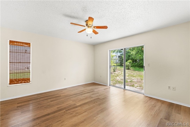 unfurnished room featuring ceiling fan, hardwood / wood-style floors, and a textured ceiling