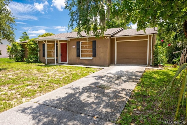 ranch-style home featuring a garage and a front lawn