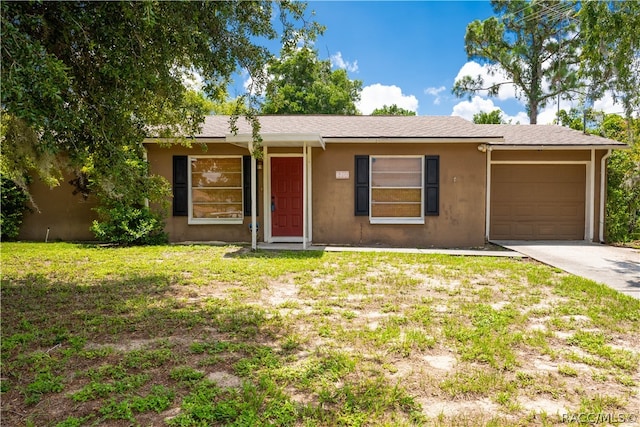 single story home featuring a garage and a front yard