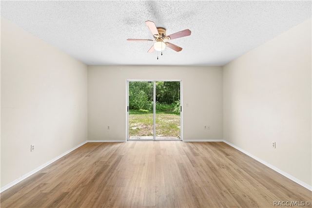 empty room with ceiling fan, a textured ceiling, and light wood-type flooring