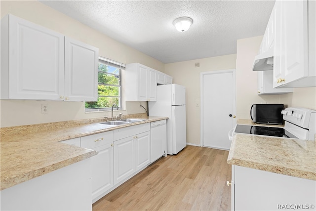 kitchen with white appliances, white cabinetry, sink, and light hardwood / wood-style flooring