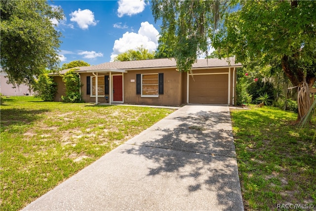 ranch-style home featuring a garage and a front lawn