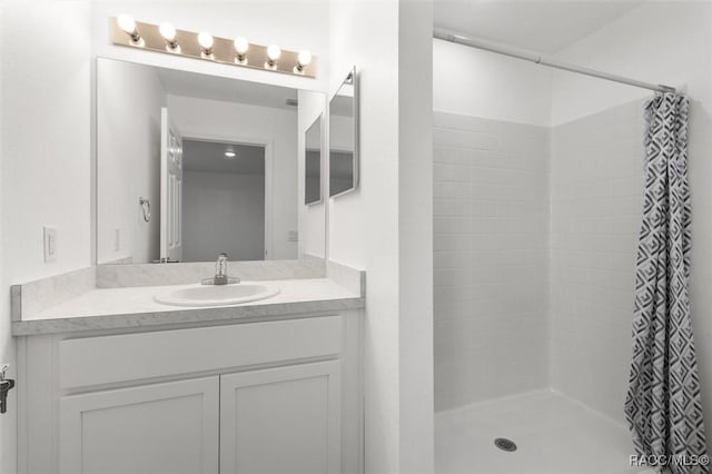 bathroom with walk in shower and vanity