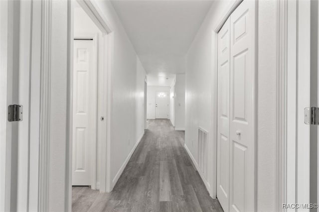 corridor with hardwood / wood-style floors