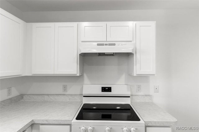 kitchen featuring white range with electric stovetop and white cabinets