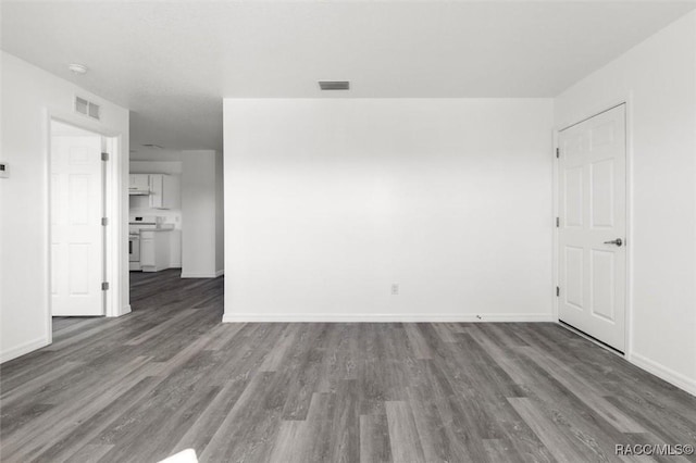 spare room with dark hardwood / wood-style floors