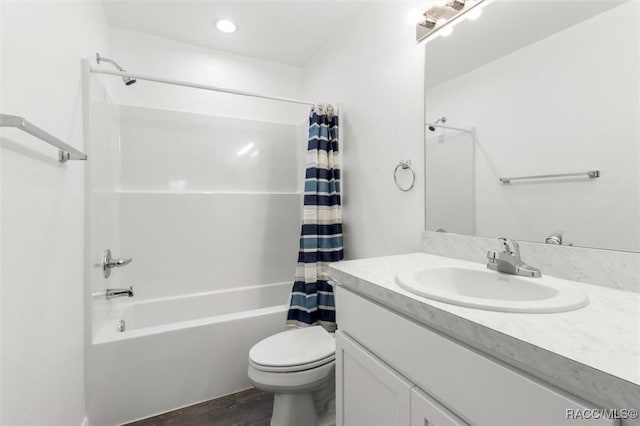 full bathroom featuring toilet, vanity, wood-type flooring, and shower / bath combo with shower curtain