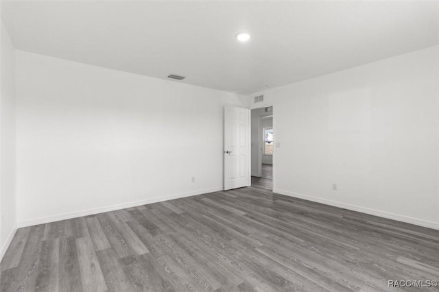 spare room featuring dark wood-type flooring