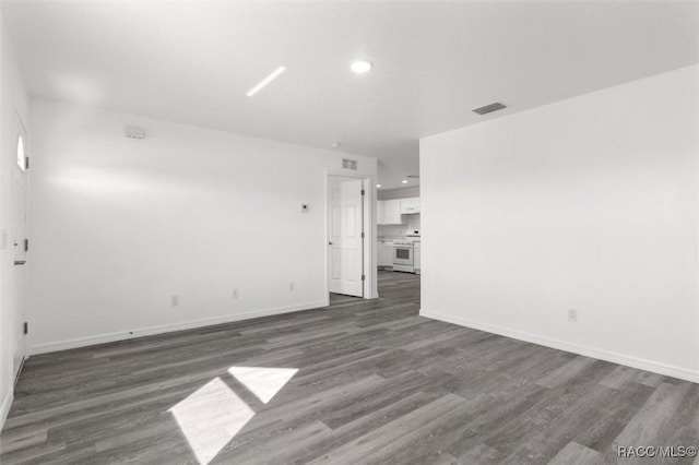 unfurnished room with dark hardwood / wood-style flooring