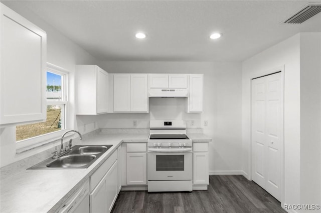 kitchen featuring dark wood-type flooring, sink, white cabinets, and white appliances