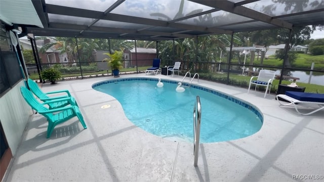 view of swimming pool with a patio area and a lanai