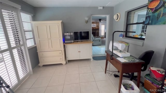 tiled office featuring ceiling fan