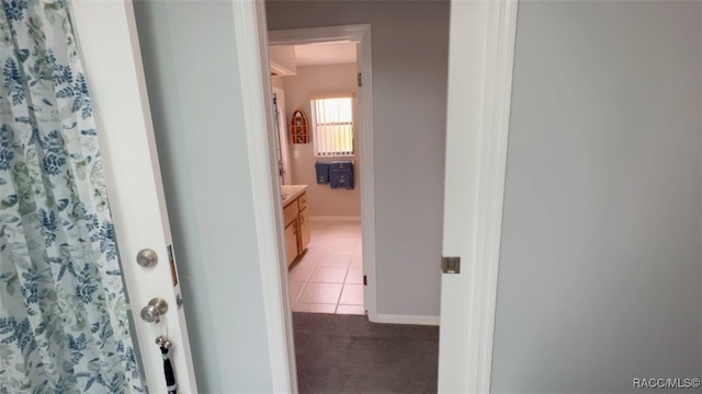 hall featuring light tile patterned flooring