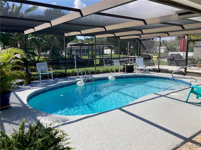 view of pool featuring a patio and glass enclosure