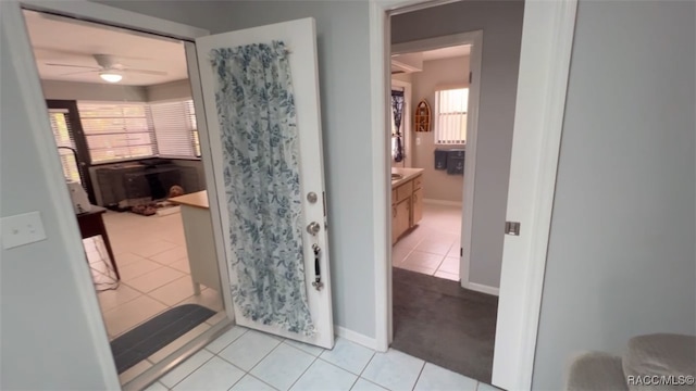 bathroom featuring tile patterned flooring, plenty of natural light, ceiling fan, and vanity