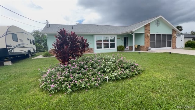 single story home with a front yard and a garage