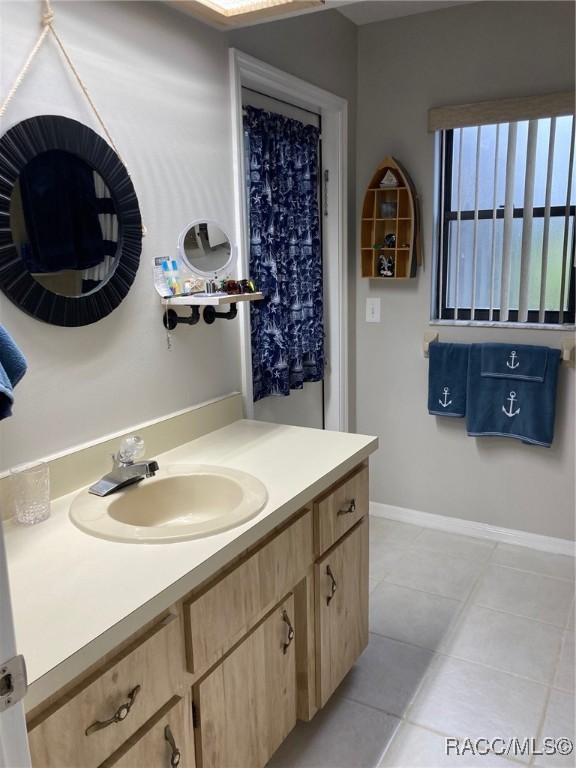 bathroom with tile patterned flooring and vanity