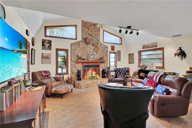 4200 W Breckenridge Ct, Beverly Hills, FL 34465 - living room featuring a stone fireplace, high vaulted ceiling, light wood-type flooring, and track lighting