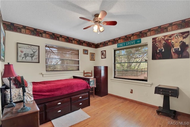4200 W Breckenridge Ct, Beverly Hills, FL 34465 - bedroom featuring light wood-style flooring, multiple windows, a textured ceiling, and a ceiling fan