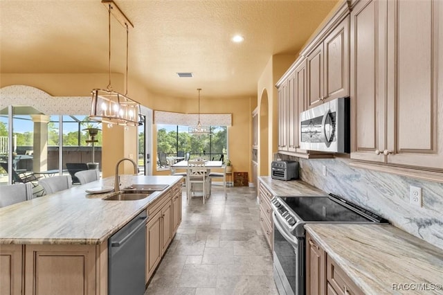 5061 W Oakhill St, Dunnellon, FL 34433 - kitchen featuring stainless steel appliances, a chandelier, recessed lighting, backsplash, and light stone finish floors