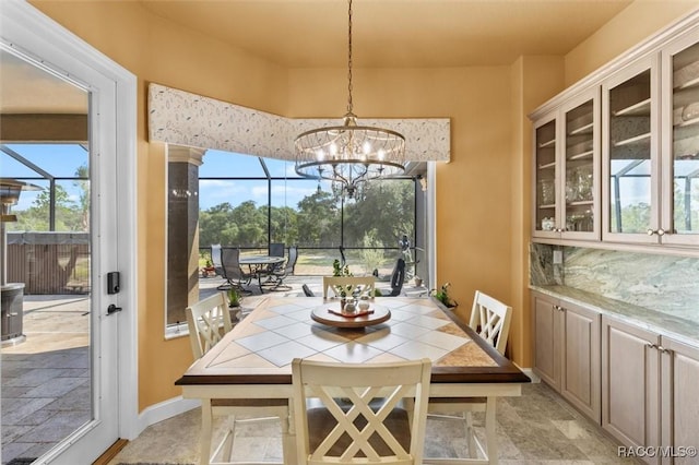 5061 W Oakhill St, Dunnellon, FL 34433 - dining space featuring a chandelier and light stone finish flooring