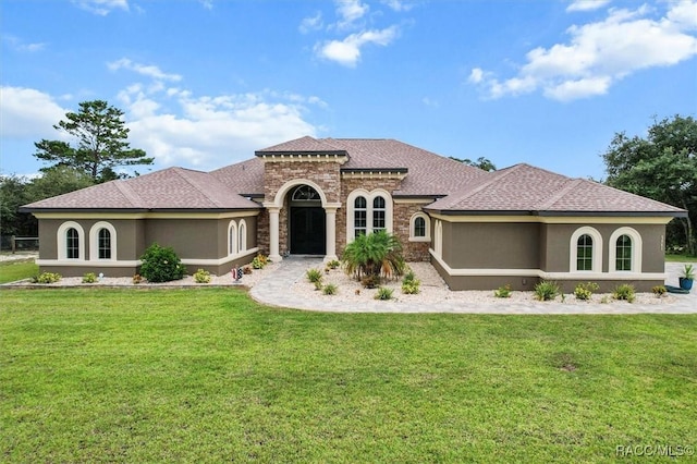 5061 W Oakhill St, Dunnellon, FL 34433 - mediterranean / spanish home with stucco siding, a front lawn, and roof with shingles