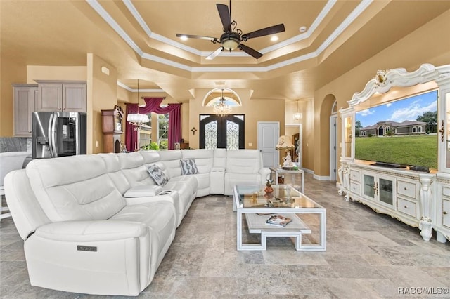 5061 W Oakhill St, Dunnellon, FL 34433 - living room featuring ornamental molding, french doors, a ceiling fan, a tray ceiling, and arched walkways