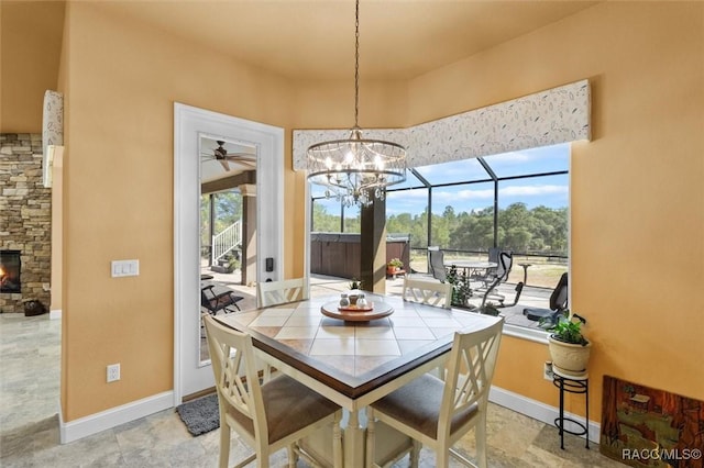 5061 W Oakhill St, Dunnellon, FL 34433 - dining area with a fireplace, ceiling fan, and a chandelier