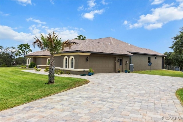 5061 W Oakhill St, Dunnellon, FL 34433 - view of front of house with stucco siding, decorative driveway, a front yard, and a garage