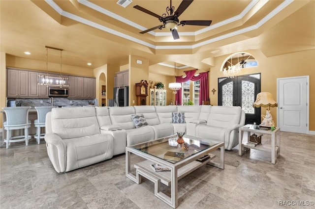 5061 W Oakhill St, Dunnellon, FL 34433 - living area with a raised ceiling, crown molding, a ceiling fan, arched walkways, and french doors