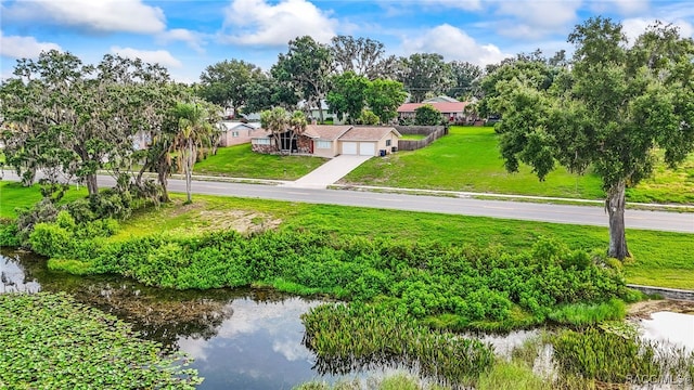 1316 Lake Ariana Blvd, Auburndale, FL 33823 - aerial view of property and surrounding area with a nearby body of water and a tree filled landscape