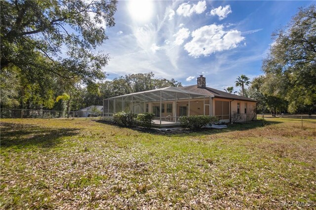 3565 S Oakdale Ter, Inverness, FL 34452 - rear view of property with a yard and glass enclosure