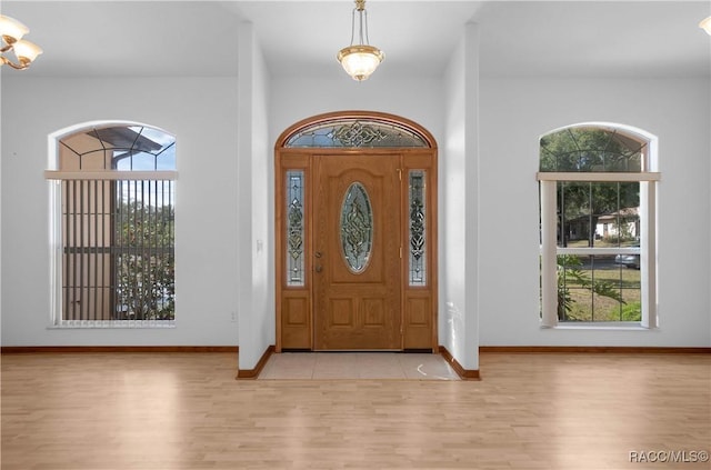3565 S Oakdale Ter, Inverness, FL 34452 - entryway with an inviting chandelier and light hardwood / wood-style flooring