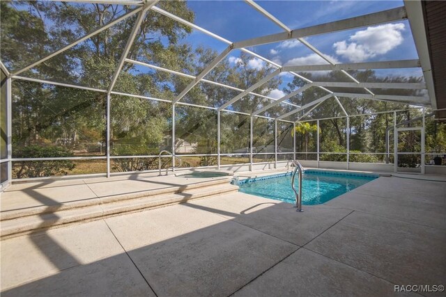 3565 S Oakdale Ter, Inverness, FL 34452 - view of swimming pool featuring glass enclosure and a patio area