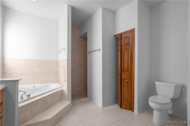 3565 S Oakdale Ter, Inverness, FL 34452 - bathroom featuring a relaxing tiled tub, tile patterned floors, vanity, and toilet