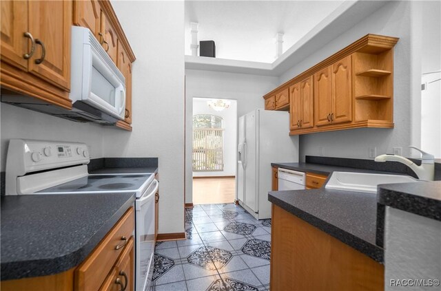 3565 S Oakdale Ter, Inverness, FL 34452 - kitchen with sink, white appliances, and light tile patterned floors