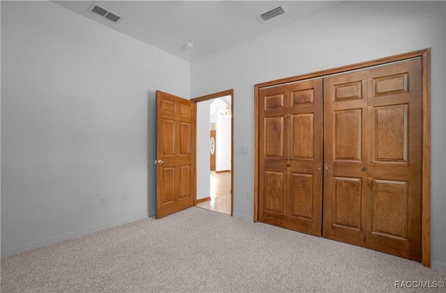 3565 S Oakdale Ter, Inverness, FL 34452 - unfurnished bedroom featuring light colored carpet and a closet