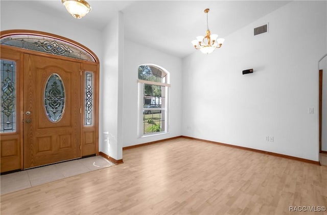 3565 S Oakdale Ter, Inverness, FL 34452 - entrance foyer featuring vaulted ceiling, a notable chandelier, and light wood-type flooring