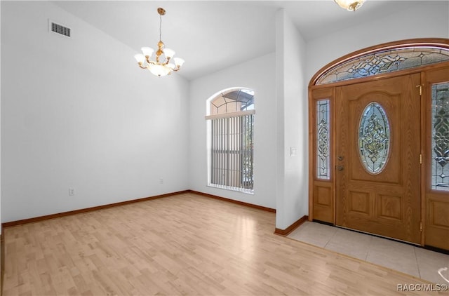 3565 S Oakdale Ter, Inverness, FL 34452 - foyer entrance with an inviting chandelier, light hardwood / wood-style flooring, and lofted ceiling