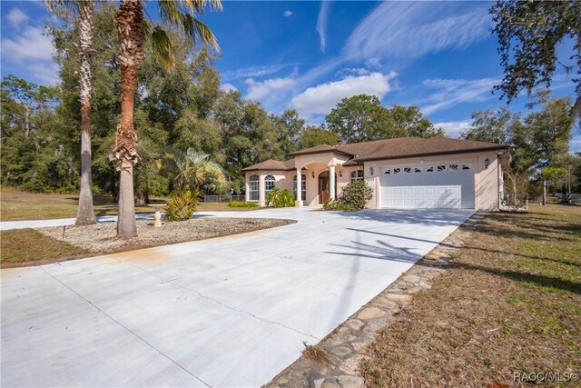3565 S Oakdale Ter, Inverness, FL 34452 - view of front of house featuring a garage and a front lawn