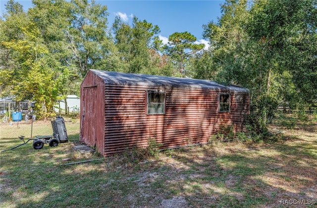 view of outbuilding featuring a yard