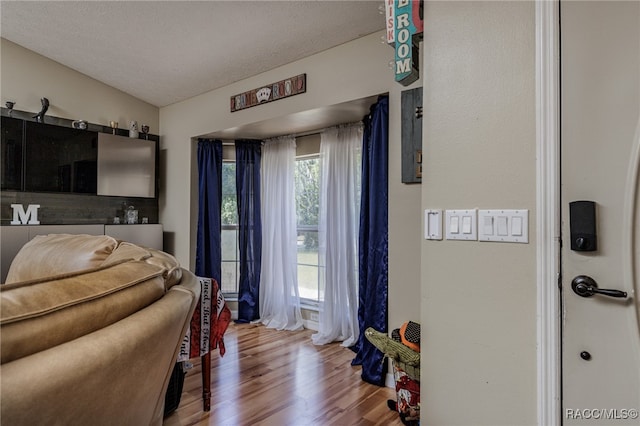 bedroom featuring a textured ceiling and hardwood / wood-style flooring