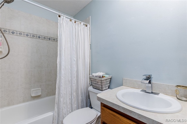 full bathroom featuring shower / bath combo, vanity, and toilet